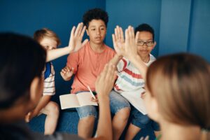 a group of kids giving high fives